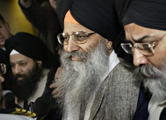 Ripudaman Singh Malik (centre) leaves B.C. Supreme Court in Vancouver, B.C. on March 16, 2005. Vancouver South Liberal candidate Ujjal Dosanjh has lodged a complaint with Elections Canada after the man acquitted of the Air India terror bombings endorsed his Conservative rival. THE CANADIAN PRESS/ Richard Lam.