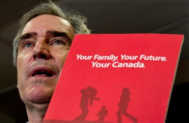 Liberal Leader Michael Ignatieff shows the party platform as he responds to a question during a news conference Monday, April 25, 2011 in Thunder Bay, Ont. THE CANADIAN PRESS/Paul Chiasson.