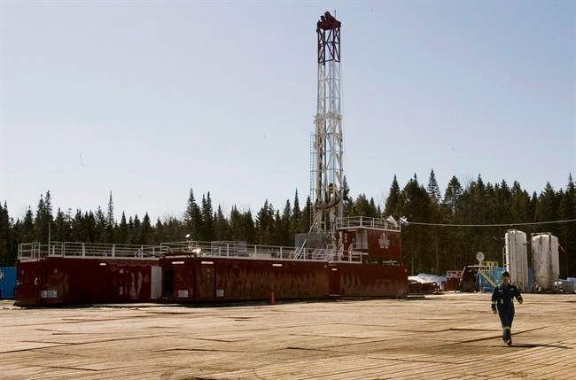 A gas worker walks from a shale gas drilling rig, on March 25, 2009 in Saint-Edouard-de-Lotbiniere Que.
