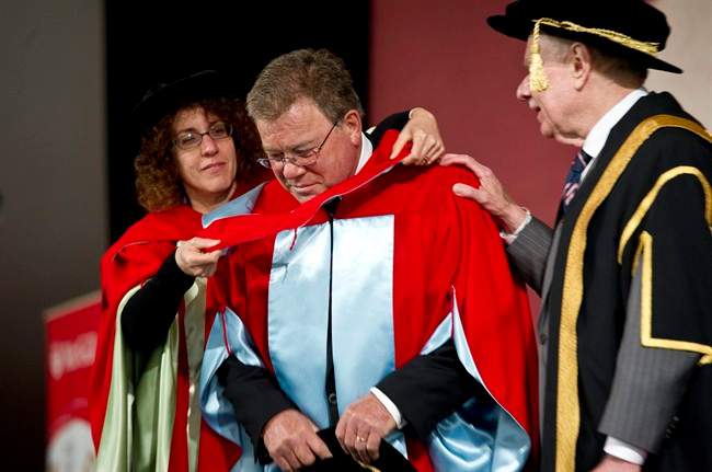 Canadian actor William Shatner is hooded by professor Victoria Kapsi and and congratulated by chancellor Arnold Steinberg as he receives an honorary degree from his alma mater McGill University, on Thursday, June 2, 2011 in Montreal. THE CANADIAN PRESS/Paul Chiasson.