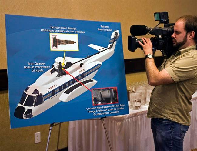 A cameraman records a display at a Transportation Safety Board of Canada news conference releasing the final report into the fatal 2009 crash of Cougar Flight 91, in St. John’s, N.L. on Wednesday, Feb. 9, 2011. The U.S. aviation regulator says it won’t require the retrofit of a gearbox blamed in a fatal helicopter crash off Newfoundland because it would be too expensive for the industry. THE CANADIAN PRESS/Andrew Vaughan