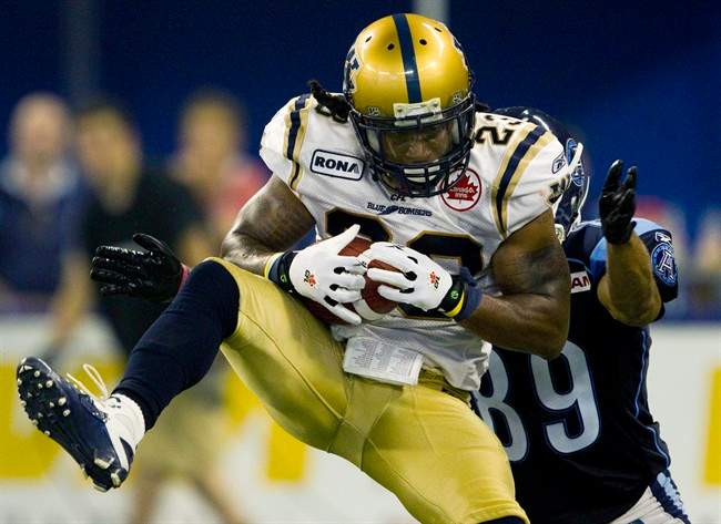 Jonathan Hefney makes an interception against Toronto Argonauts wide receiver Spencer Watt during a CFL game in Toronto in July 2011.