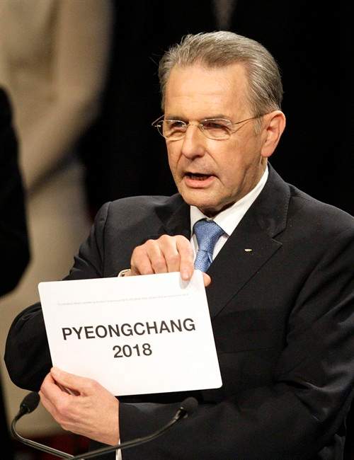 International Olympic Committee President Jacques Rogge opens the envelope announcing that Pyeongchang has won the bid to host the 2018 Olympic Winter Games in Durban, South Africa, Wednesday July 6, 2011. The IOC announced it voted for Pyeongchang to be the host city for the 2018 Winter Olympics.The IOC voted by secret ballot from a field of three candidates _ Pyeongchang, South Korea; Munich; and Annecy, France. (AP Photo/Themba Hadebe).