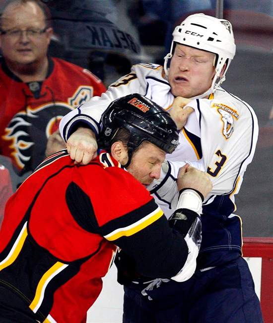 Nashville Predators' Wade Belak, right, fights with Calgary Flames' Brian McGratton during first period NHL hockey action in Calgary, Friday, Jan. 15, 2010. Former NHL enforcer Wade Belak has been found dead. A spokesman with the Nashville Predators confirmed Wednesday night that Belak was found dead in Toronto. THE CANADIAN PRESS/Jeff McIntosh.