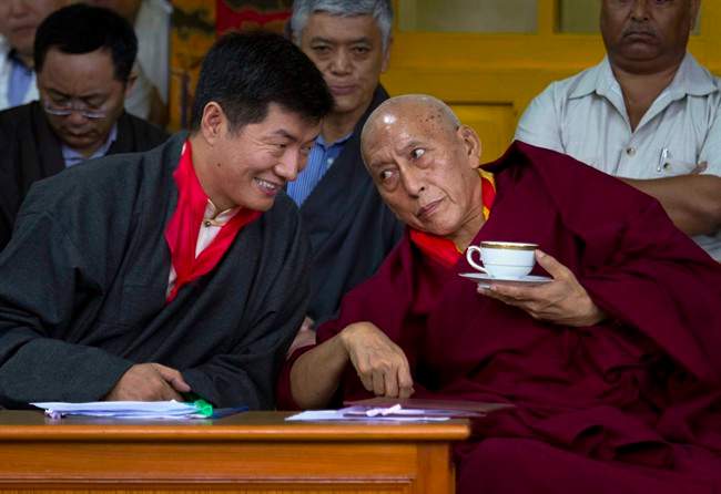 Lobsang Sangay, left, the new prime minister of Tibet's government in exile, speaks with outgoing Prime Minister Samdhong Rinpoche during his swearing-in ceremony at the Tsuglakhang Temple in Dharmsala, India, Monday, Aug. 8, 2011. (AP Photo/Ashwini Bhatia).