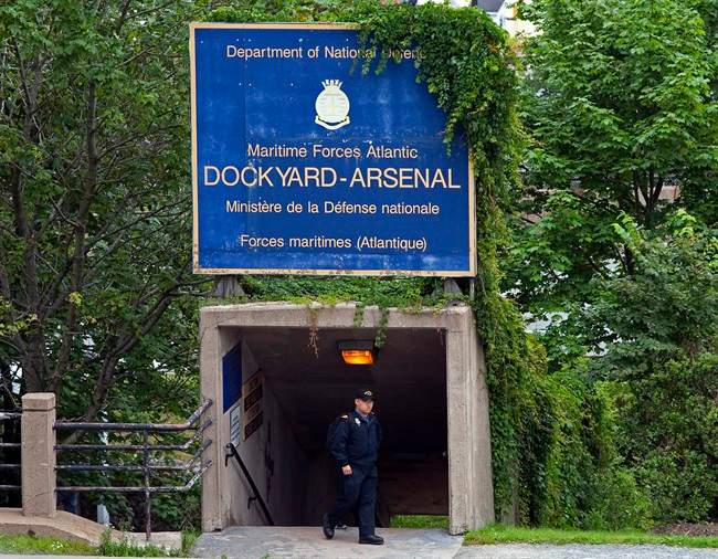A sailor walks under signage at Maritime Forces Dockyard in Halifax on Monday, Aug. 15, 2011. Defence Minister Peter MacKay is expected to announce a name change to the Royal Canadian Navy, the Royal Canadian Air Force and Canadian Army for the armed forces. The three branches of the military have been known formally as Air Command, Maritime Command and Land Force Command since 1968, when federal law unified them under the Canadian Forces banner. THE CANADIAN PRESS/Andrew Vaughan.