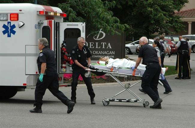 Paramedics take one of several victims of a shooting outside of the Delta Grand hotel in downtown Kelowna, B.C., to hospital on Sunday, April 14, 2011. THE CANADIAN PRESS/The Daily Courier- J.P. Squire.