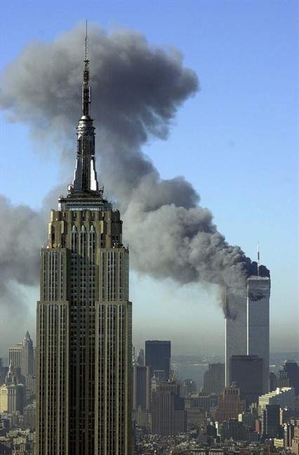 Plumes of smoke rise from the World Trade Center buildings in New York on Sept. 11, 2001. (AP Photo/Patrick Sison, File)