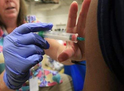 Nurse Susan Peel gives a whooping cough vaccination to a student at Inderkum High School, Monday, Sept. 19, 2011, in Sacramento, Calif. (AP Photo/Rich Pedroncelli).