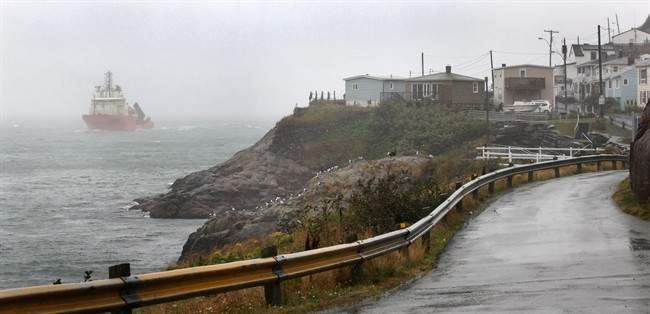 The offshore supply vessel Atlantic Osprey enters the St. John's Narrows in the fog and rain generated by post-tropical storm Maria. THE CANADIAN PRESS/Paul Daly.