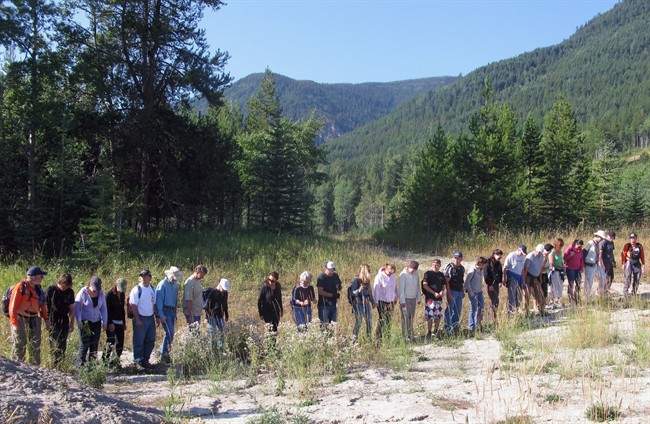 A group of volunteers scour an area near the home of a missing three-year-old in Sparwood, B.C. on Saturday September 10, 2011.