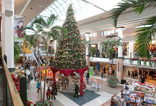 Christmas shoppers walk to stores at a shopping centre in Quebec City.