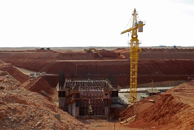 A crane hovers above the site of a new shaft under construction at the Ivanhoe Mines' Oyu Tolgoi mine site in Khanbogd village, Umnugobi province, Mongolia Saturday Nov. 7, 2009. T.