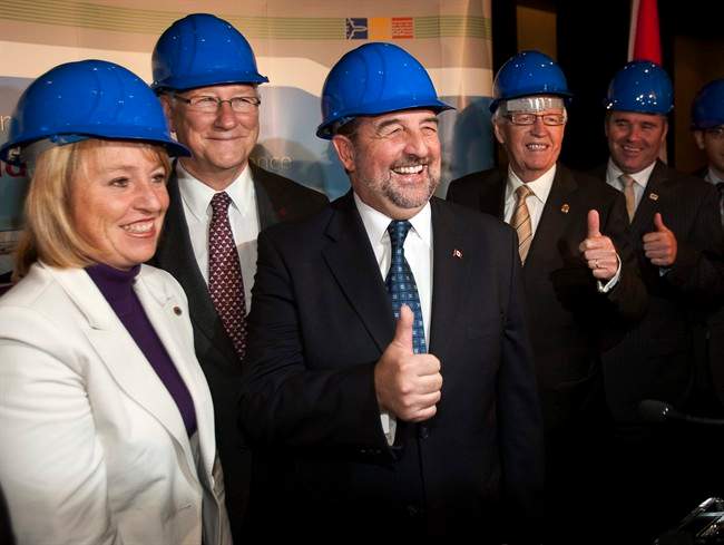 Federal Transport Minister Denis Lebel, center, poses with Longueuil Mayor Caroline St-Hilaire, left, Montreal Mayor Gerald Tremblay, 2nd left, and other dignitaries at a news conference to announce plans for a new bridge to replace the Champlain Bridge, on Wednesday, October 5, 2011 in Montreal. THE CANADIAN PRESS/Ryan Remiorz.