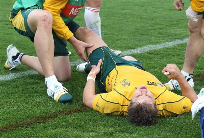 Australia's Drew Mitchell reacts after injurying his leg during their Rugby World Cup match against Russia at Trafalgar Park in Nelson, New Zealand, Saturday, Oct. 1, 2011.(AP Photo/Rob Griffith).