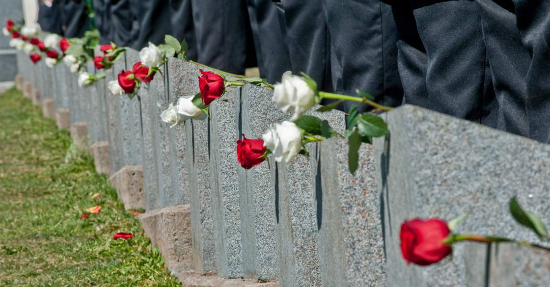Flowers are placed on tombstones during a public interfaith memorial service at the Fairview Lawn Cemetery in Halifax on April 15, 2012 in remembrance of the lives lost in the Titanic tragedy and of the 121 Titanic victims buried at the cemetery.
