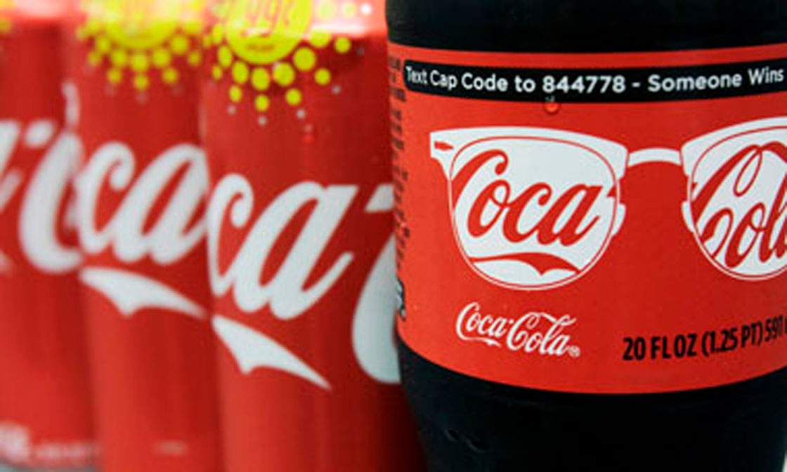 A variety of Coca-Cola cans and bottles are displayed on a counter at a local store in West Bath, Maine, Monday, Aug. 8, 2011, in this photo illustration. Coca-Cola Bottling Co. reports quarterly financial results Tuesday, Aug. 9, after the market close.