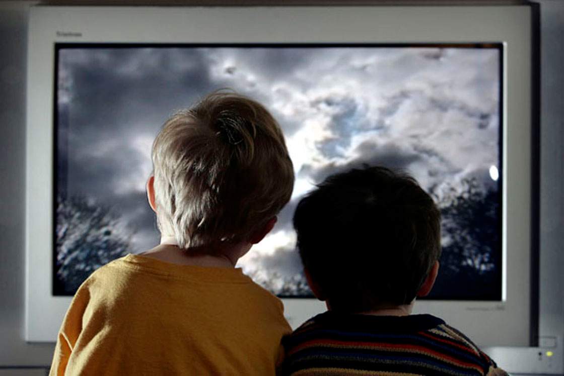 In this photo illustration two young child watch television at home;January 27, 2005 in London;England.