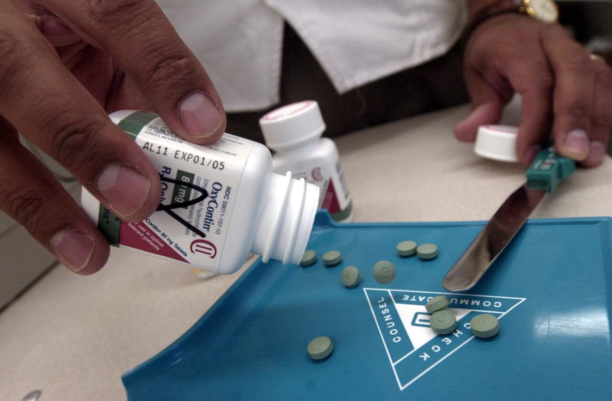 Opposition critics in New Brunswick say the Conservative government is purposely delaying implementation of a catastrophic drug program.