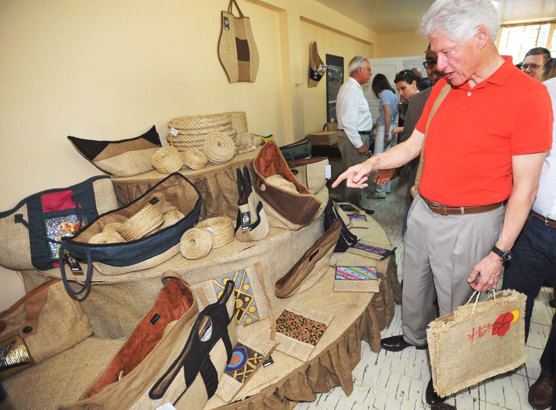 Former US President Bill Clinton with an agricultural investment delegation visiting Sisal Company on March 11 2013 in Port-au-Prince, Haiti. 