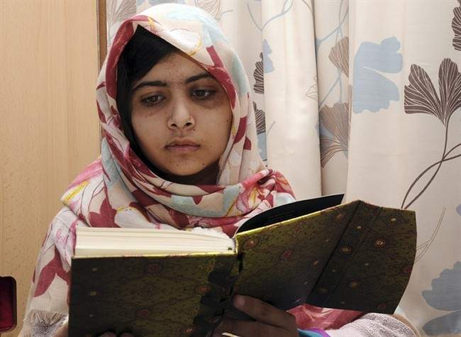 FILE - In this undated file photo provided by Queen Elizabeth Hospital in Birmingham, England, Malala Yousufzai reads a book.