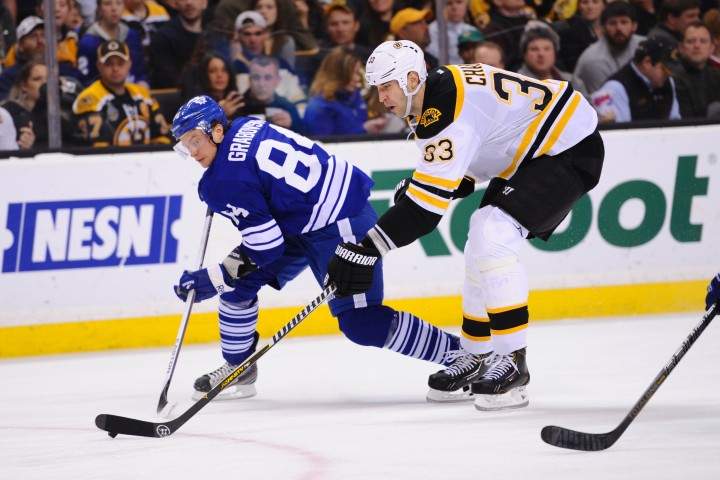 Zdeno Chara #33 of the Boston Bruins skates with the puck against Mikhail Grabovski #84 of the Toronto Maple Leafs at the TD Garden on March 25, 2013 in Boston, Massachusetts. 