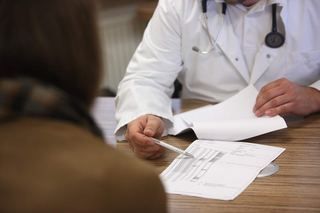 A doctor speaks to a patient
