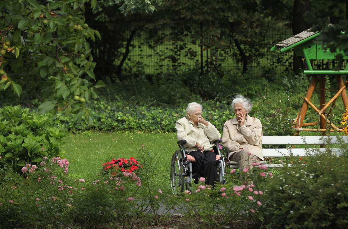 Two elderly women sit and chat in the gardens of the Sewanstrasse senior care home in Lichtenberg district on August 30, 2011 in Berlin, Germany.
