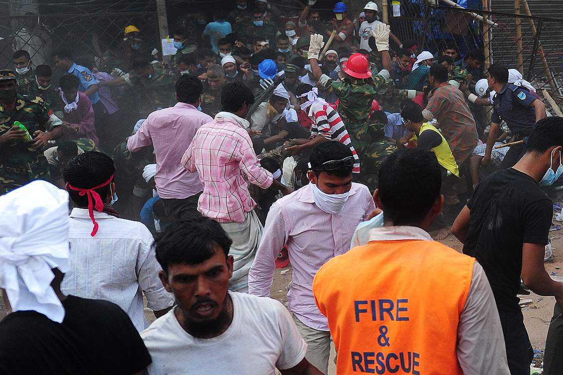 Bangladeshi army personal and volunteers run for a safe place after a rumour spread that the building was going to collapse more, 48 hours after an eight-storey building first collapsed in Savar, on the outskirts of Dhaka, on April 26, 2013.  (Getty Images)