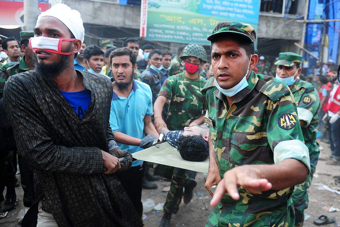Bangladeshi army personal carry a survivor after he was recovered, 48 hours later, from the rubble of a collapsed eight-storey building in Savar, on the outskirts of Dhaka, on April 26, 2013.  (Getty Images)