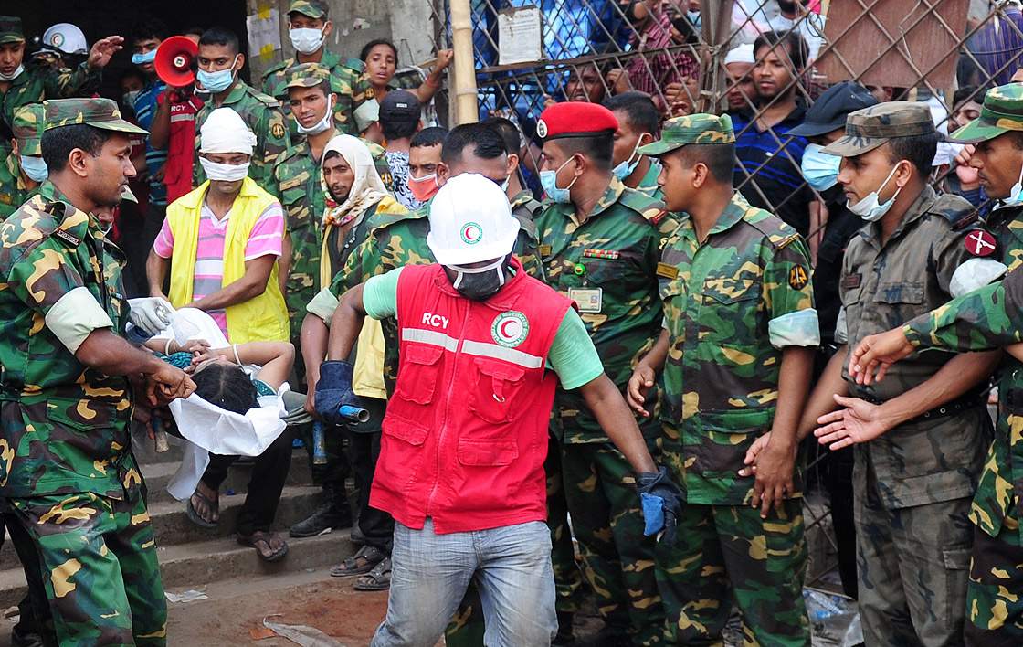 Bangladeshi army personal carry a survivor after he was recovered, 48 hours later, from the rubble of a collapsed eight-storey building in Savar, on the outskirts of Dhaka, on April 26, 2013.  (Getty Images)