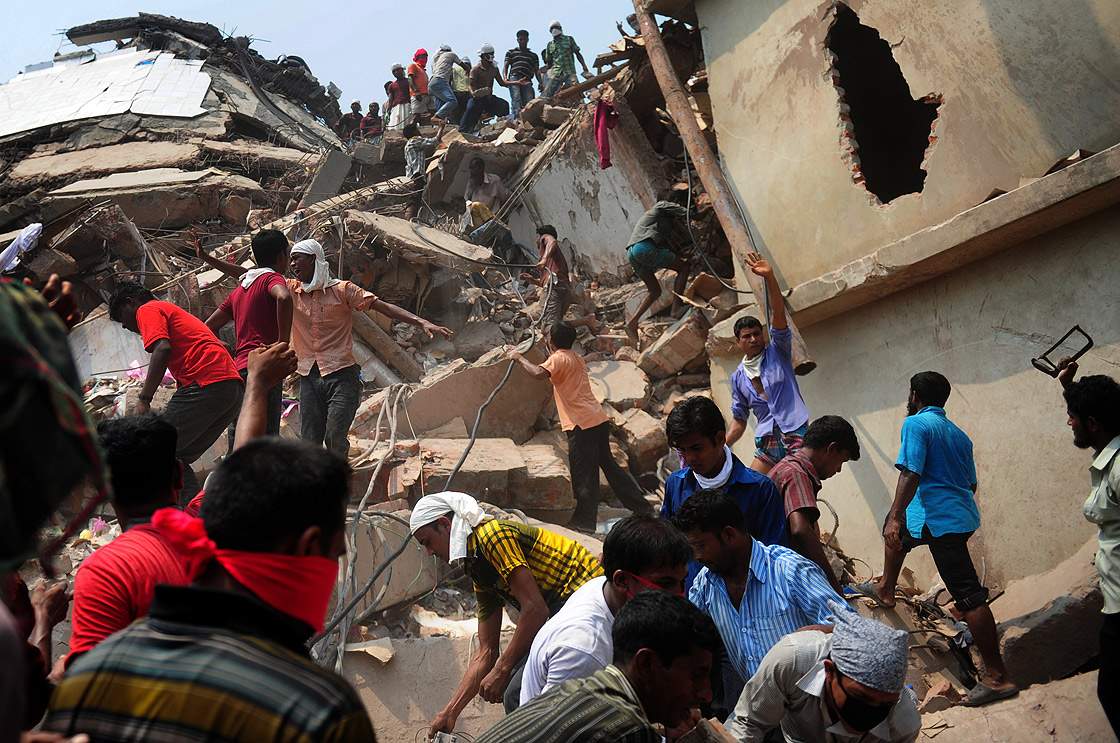 Bangladeshi volunteers and rescue workers assist in rescue operations 48 hours after an eight-storey building collapsed in Savar, on the outskirts of Dhaka, on April 26, 2013.  (Getty Images)