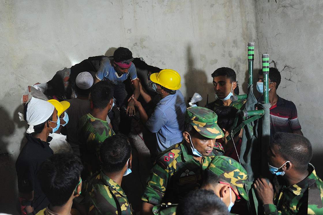 A Bangladeshi volunteer comes out from the rubble 48 hours after an eight-storey building collapsed in Savar, on the outskirts of Dhaka, on April 26, 2013.  (Getty Images)