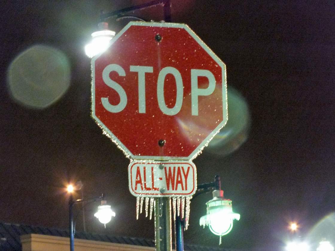 Ice covers a road sign in Brampton, Ontario on April 12, 2013. Environment Canada issued an ice storm warning Friday morning for a large portion of the Greater Toronto Area.  