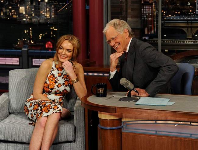In this Tuesday, April 9, 2013 photo released by CBS Entertainment, actress Lindsay Lohan talks to David Letterman about her upcoming trip to rehab.