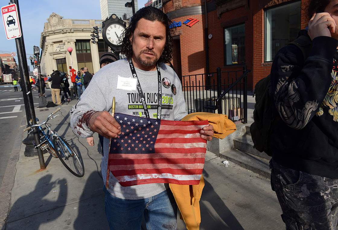 Carlos Arredondo, who was at the finish line of the 117th Boston Marathon when two explosives detonated, leaves the scene on April 15, 2013 in Boston, Massachusetts. Arredondo is also being hailed as a hero as he rushed to help victims just seconds after the first explosion.