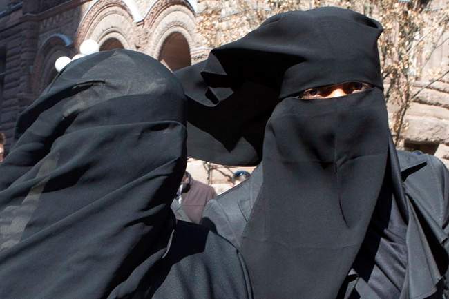Unidentified women wear niqabs outside an Ontario court house in Toronto on Tuesday April 23, 2013.