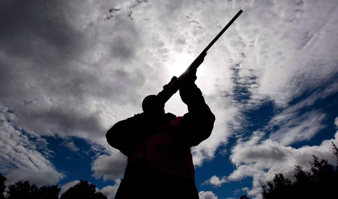 A rifle owner checks the sight of his rifle at a hunting camp property in rural Ontario west of Ottawa in this Sept. 15, 2010 file photo. 