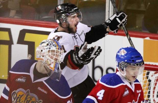 Brooks Macek of the Calgary Hitmen celebrates after scoring the winning goal in overtime against the Edmonton Oil Kings in the sixth game of the Western Hockey League’s Eastern Conference final on Sunday at the Scotiabank Saddledome.