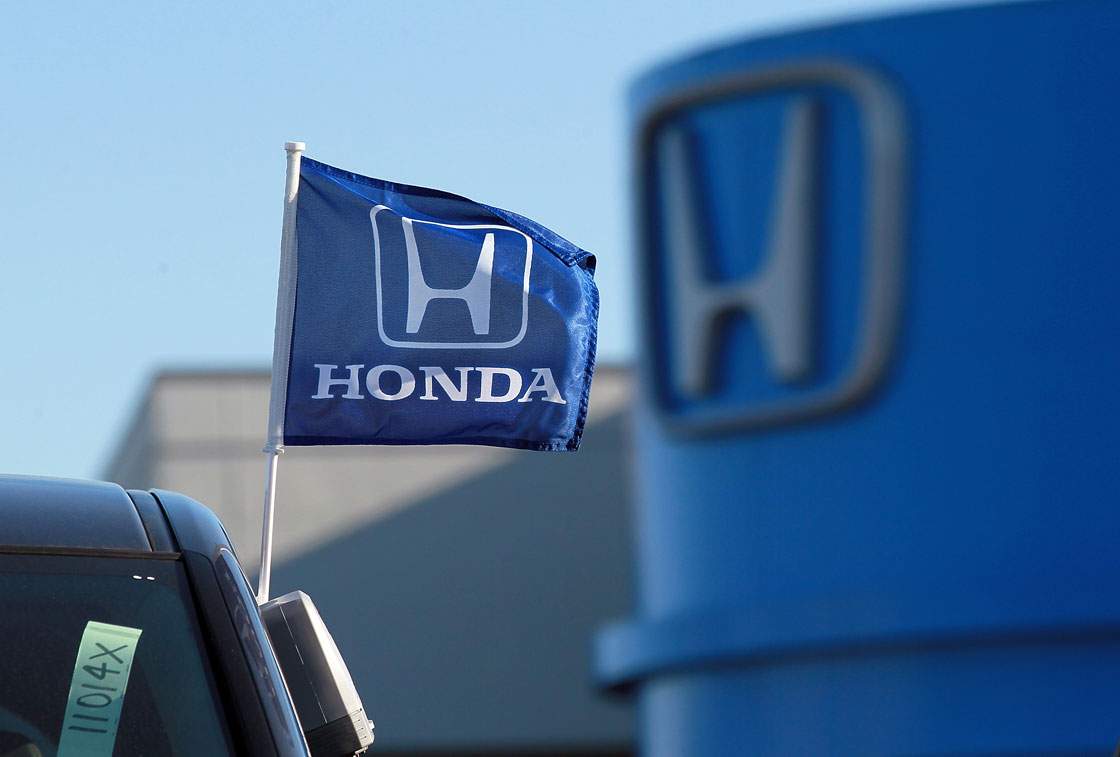 A flag with the Honda logo is displayed on brand new car at a dealership on December 2, 2011. 
