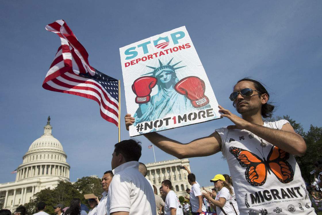 Cesar Maxit, of Washington, who is originally from Argentina, hold a sign that says "Stop Deportations" at the Rally for Citizenship, a rally in support of immigration reform, on Capitol Hill in Washington, on Wednesday, April 10, 2013. Bipartisan groups in the House and Senate are said to be completing immigration bills that include a pathway to citizenship for the nation's 11 million immigrants with illegal status. 