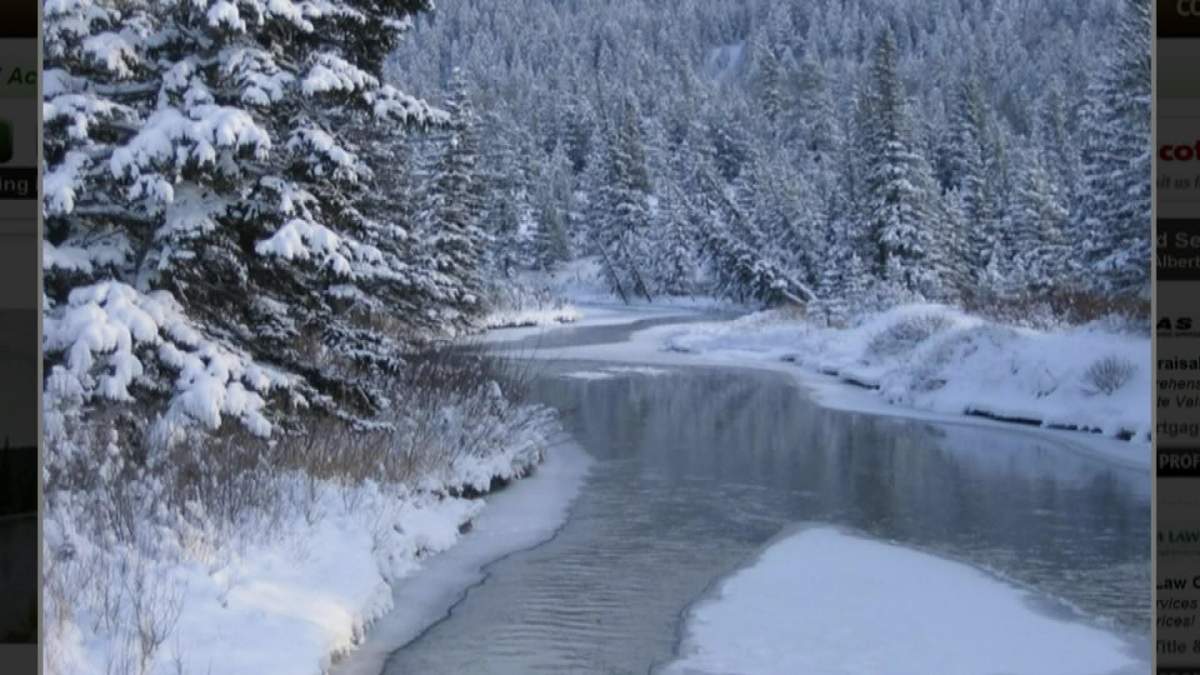 An online listing of a Coleman, AB acreage being sold for digital currency shows a view of the Crowsnest River.