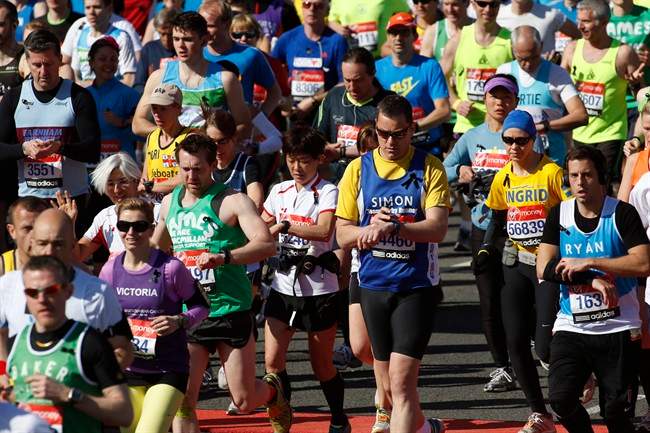 Runners wear black ribbons in memory of the victims of Boston Marathon bombings start the race during the London Marathon, London, Sunday, April 21, 2013.