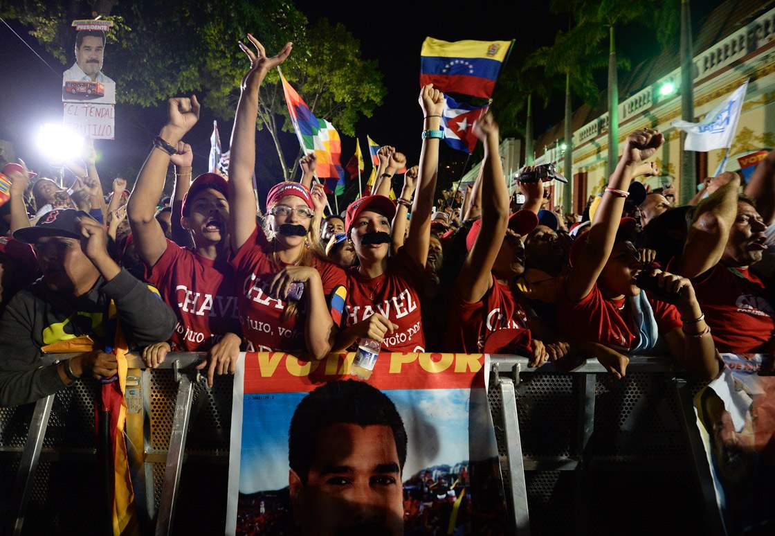 Supporters of Venezuelan acting President Nicolas Maduro celebrate after knowing the election results in Caracas on April 14, 2013. 