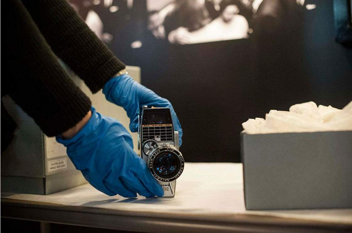Staff from the Newseum and National Archives install rarely-seen artifacts, on loan from the National Archives, in the Newseum exhibit "JFK: Three Shots Were Fired." Pictured: Dallas businessman Abraham Zapruder used this Bell & Howell 8 mm home movie camera to film President John F. Kennedy's motorcade on Nov. 22, 1963. Zapruder was the only eyewitness to capture the entire assassination on film. Photo: Maria Bryk/Newseum; camera: Courtesy National Archives and Records Administration, Washington, DC.