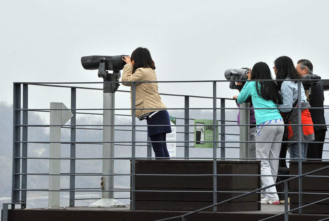 Visitors look toward the north side at Imjingak peace park near the demilitarized zone dividing the two Koreas in the border city of Paju on April 5, 2013.