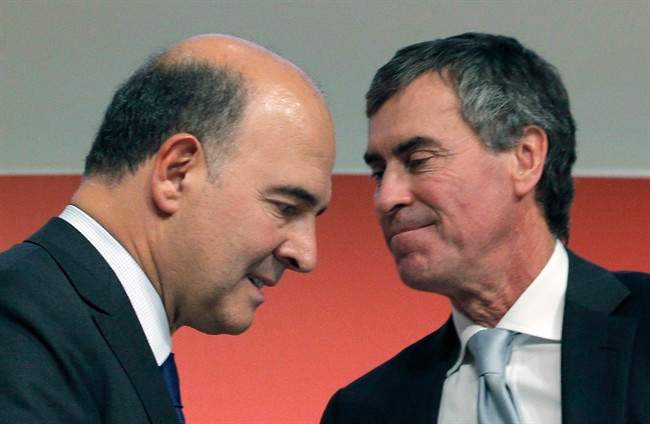 FILE - In this Sept. 28, 2012 file photo, France's Finance Minister Pierre Moscovici, left, and then Budget Minister Jerome Cahuzac attend a press conference in Paris. Francois Hollande is a President on the ropes, reeling from a potentially knockout blow delivered by his ex-budget minister, a man who admitted this week that he had hidden hundreds of thousands of euros from the taxman for decades and lied about it. Those lies from Jerome Cahuzac came both in front of the National Assembly and to Hollande's own face.