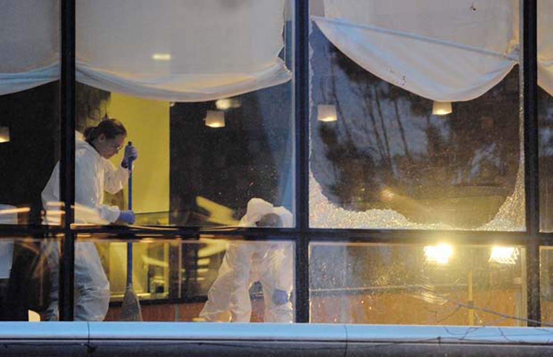 Workers clean up a restaurant at the Wall Centre after long-time gangster Sandip (Dip) Duhre was gunned down execution-style by someone he was meeting.
