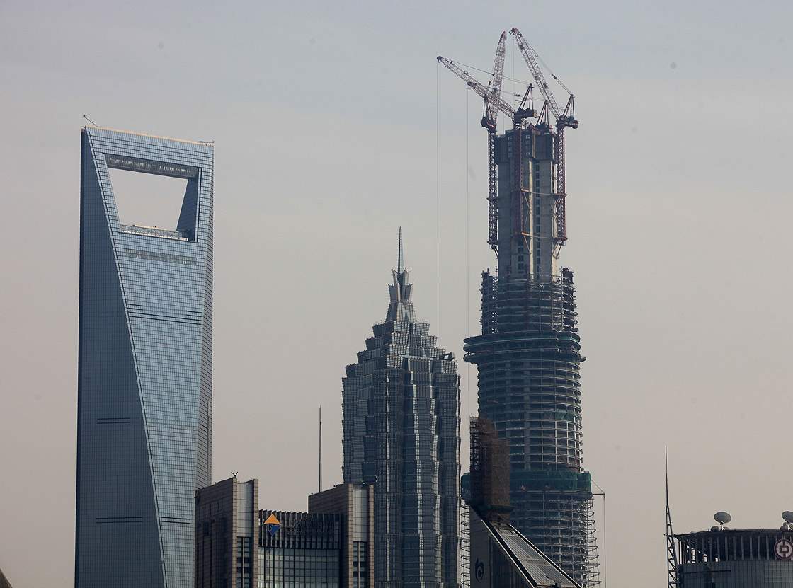 The Jin Mao Tower (C), the Shanghai World Financial Center (L) and the under construction Shanghai Tower (R) stand in Lujiazui financial district on April 11, 2013 in Shanghai, China.