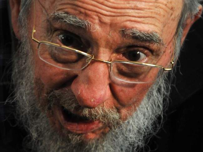 FILE - In this Feb. 3, 2013 file photo, Fidel Castro talks to reporters at a polling station after casting his ballot in parliament elections in Havana, Cuba. 